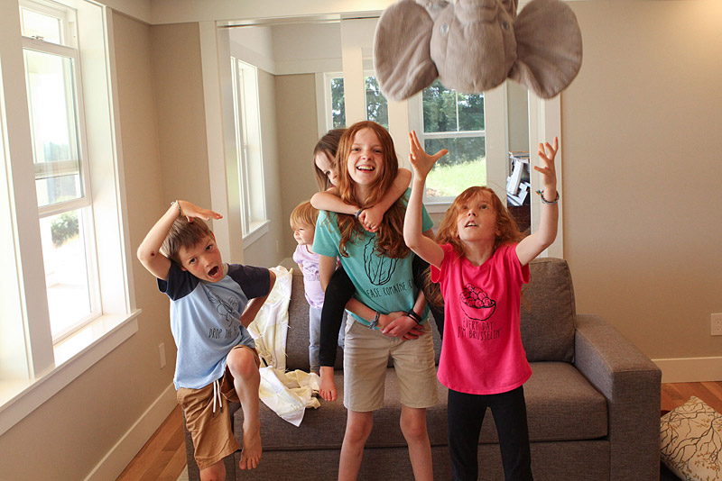 family of 5 happy vegetable eating kids goofing off